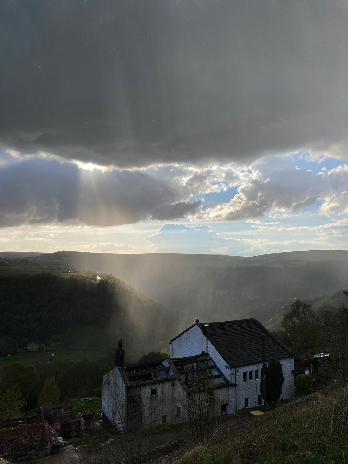 Panoramic view of an old cottage under cloudy sky