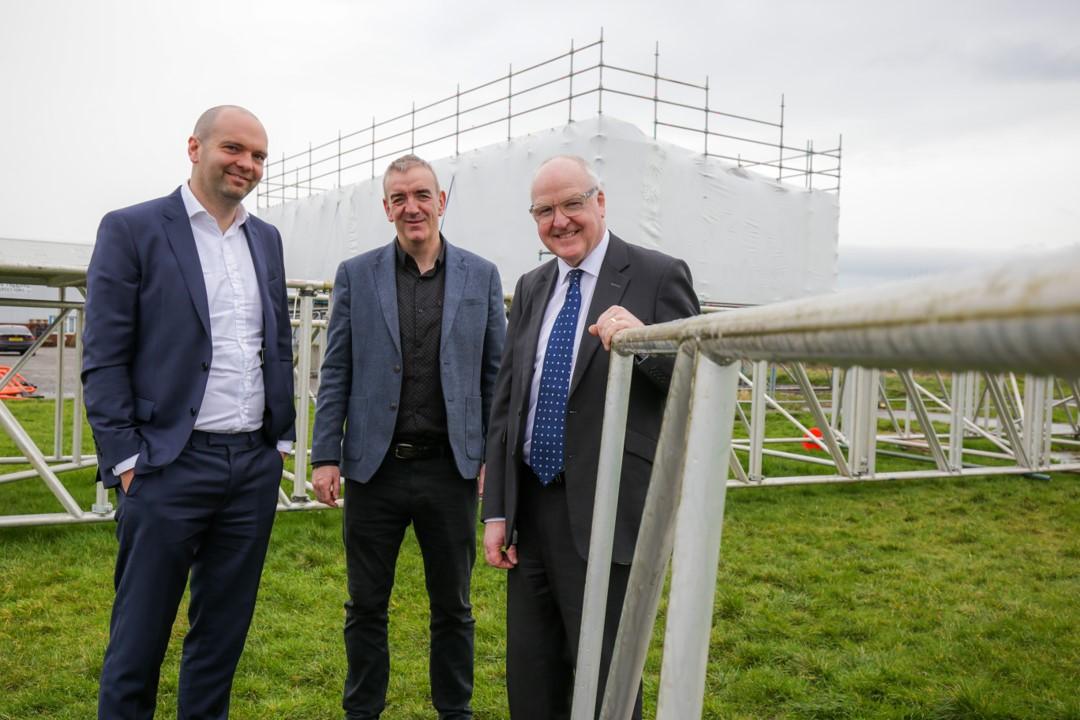 Photo of David Tindall from British Business Bank, Rhodri Evans from FW Capital and Michael Carr, CEO of Palmers standing outside in front of some scaffolding