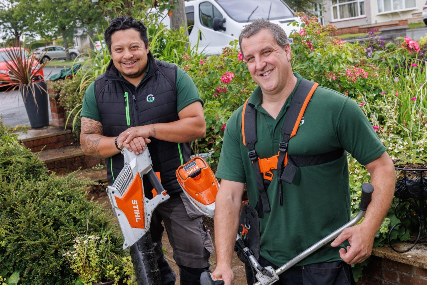 Photo of Will Thomas and Matt Craven from Green Dream Concepts in a garden with gardening equipment